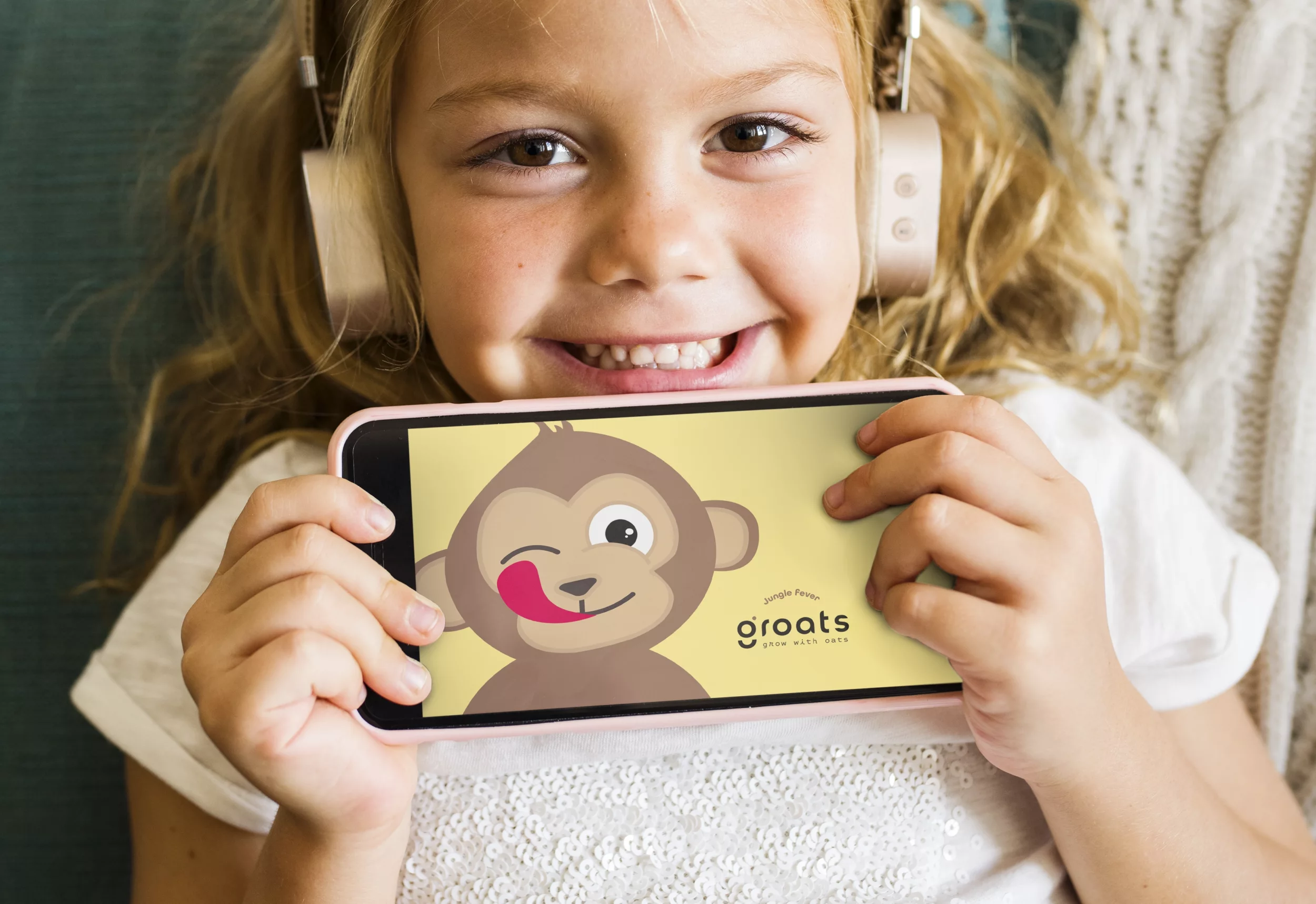 Visual van een vrolijk kindje met Groats op de GSM.